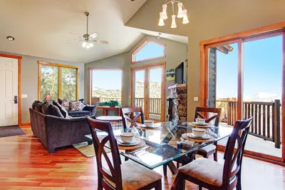 a living room with a table and a couch at Mount Cairns 16A Condo in Estes Park
