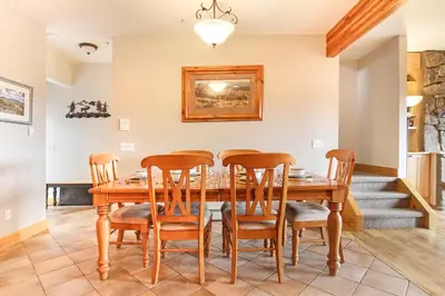 a dining room with a wooden table and chairs at Mount Chapin S4 Condo in Estes Park
