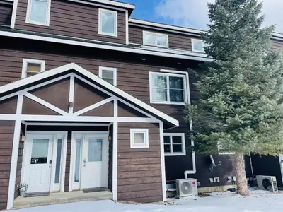 a house with a garage in front of it at Mount Chapin S4 Condo in Estes Park