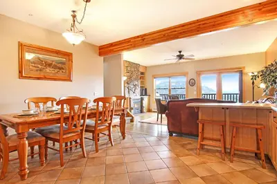 a dining room and living room with a table and chairs at Mount Chapin S4 Condo in Estes Park