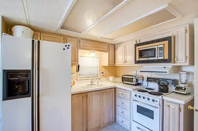 a kitchen with white appliances and a white refrigerator at #84 in Breckenridge