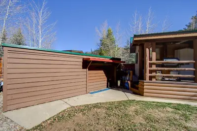 a building with a garage next to a house at #84 in Breckenridge