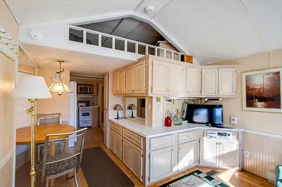 a kitchen with white cabinets and a table and a microwave at #84 in Breckenridge