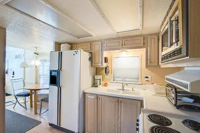 a kitchen with a white refrigerator and a table at #84 in Breckenridge