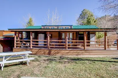a large wooden house with a picnic table in front of it at #84 in Breckenridge