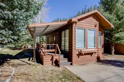 a small cabin with a porch and a staircase at #244 in Breckenridge