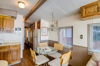 a kitchen and dining room with a glass table and chairs at #244 in Breckenridge