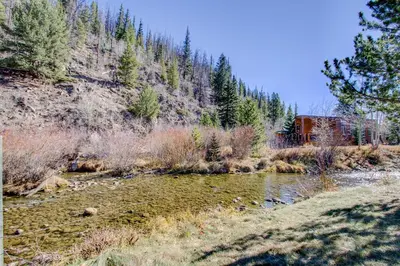 a river with a house on the side of a mountain at #244 in Breckenridge