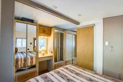 a bedroom with two beds and a mirror at #244 in Breckenridge