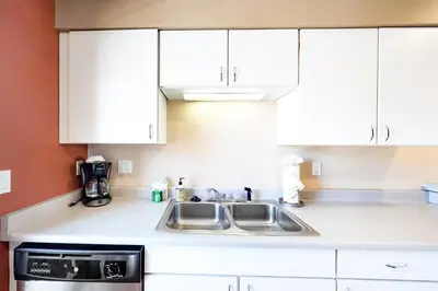 a kitchen with white cabinets and a sink at Lagoon 737C in Frisco