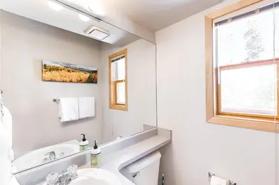 a white bathroom with a sink and a mirror at Lagoon 737C in Frisco