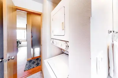 a bathroom with a washing machine and a mirror at Lagoon 737C in Frisco