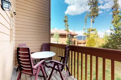 a patio with two chairs and a table on a balcony at Lagoon 737C in Frisco