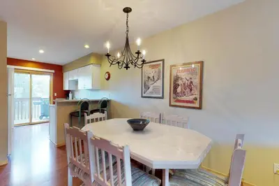 a kitchen and dining room with a table and chairs at Lagoon 737C in Frisco