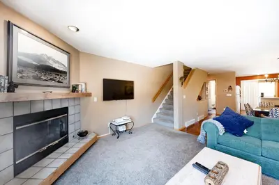a living room with a blue couch and a fireplace at Lagoon 737C in Frisco