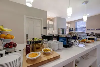a kitchen with bowls of food on a counter at Homewood Suites by Hilton Boulder in Boulder
