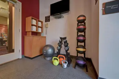 a room with a shelf with various exercise equipment at Homewood Suites by Hilton Boulder in Boulder