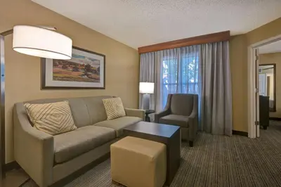 a living room with a couch and a chair at Homewood Suites by Hilton Boulder in Boulder