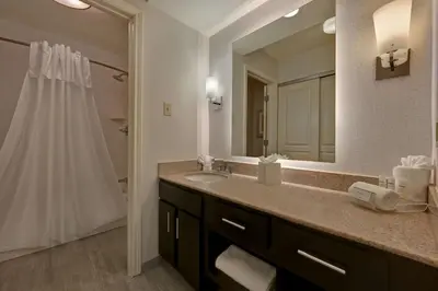 a bathroom with a sink and a large mirror at Homewood Suites by Hilton Boulder in Boulder