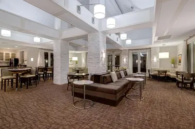 a lobby with a couch and tables and chairs at Homewood Suites by Hilton Boulder in Boulder