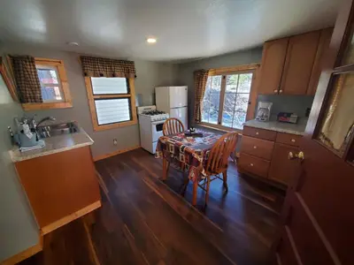 a kitchen with a table and chairs in a room at Swiftcurrent Lodge in Estes Park