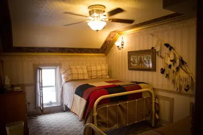 a bedroom with a bed with a ceiling fan at Frisco Lodge in Frisco