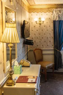 a room with a desk with a lamp and a chair at Frisco Lodge in Frisco