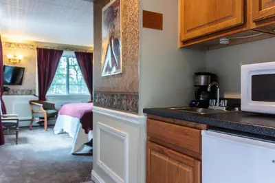 a kitchen with a microwave and a room with a bed at Frisco Lodge in Frisco