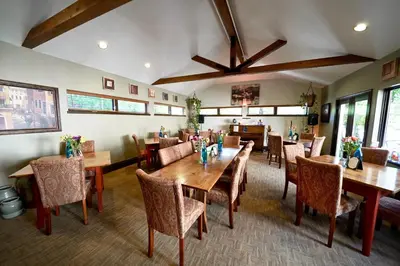 a dining room with wooden tables and chairs at Frisco Inn on Galena in Frisco