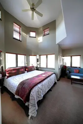 a bedroom with a bed and a ceiling fan at Frisco Inn on Galena in Frisco