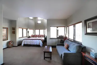 a living room with a couch and a bed at Frisco Inn on Galena in Frisco
