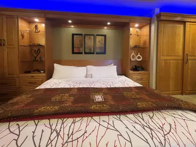 a bedroom with a large bed with wooden cabinets at Frisco Inn on Galena in Frisco