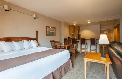 a hotel room with a bed and a couch at The Vintage Hotel in Winter Park