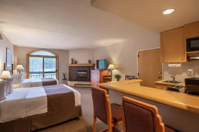a hotel room with a bed and a kitchen at The Vintage Hotel in Winter Park