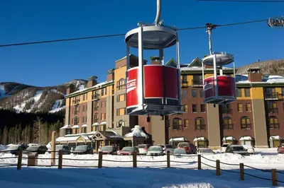 a ski lift in front of a large building at The Vintage Hotel in Winter Park