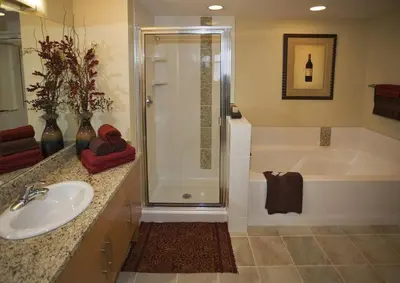a bathroom with a shower and a sink and a tub at Fraser Crossing and Founders Pointe in Winter Park