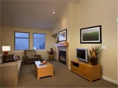 a living room with a couch and a tv and a fireplace at Fraser Crossing and Founders Pointe in Winter Park