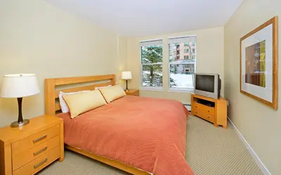 a bedroom with a bed and a television at Fraser Crossing and Founders Pointe in Winter Park