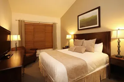 a hotel room with a large bed and a window at Zephyr Mountain Lodge in Winter Park