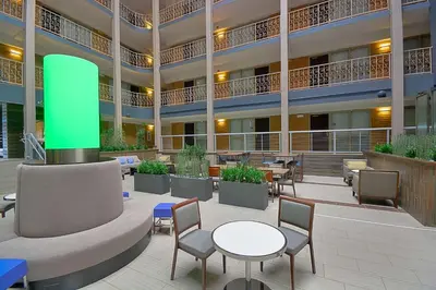 arium of a hotel with tables and chairs and a building at Embassy Suites by Hilton Denver Central Park in Denver