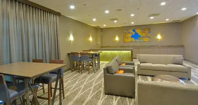 a waiting room with a couch and a table at Embassy Suites by Hilton Denver Central Park in Denver