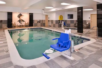 a swimming pool with a blue chair in a hotel room at Hampton Inn & Suites Denver-Speer Boulevard in Denver