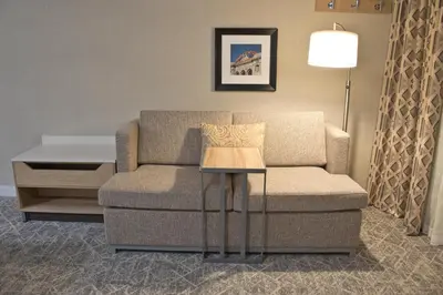 a living room with a couch and a table at Hampton Inn & Suites Denver-Speer Boulevard in Denver