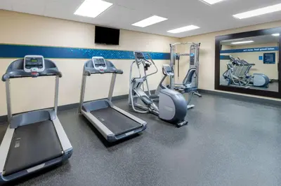 a gym with cardio equipment in a room at Hampton Inn Denver-International Airport in Denver