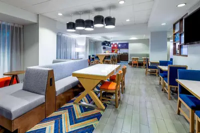 a dining room with a table and chairs and a table and chairsktop at Hampton Inn Denver-International Airport in Denver