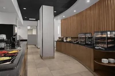 a buffet line in a restaurant with food on display at Hilton Garden Inn Denver Downtown in Denver