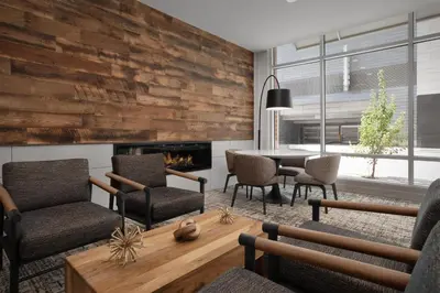 a living room with a table and chairs and a fireplace at Hilton Garden Inn Denver Downtown in Denver