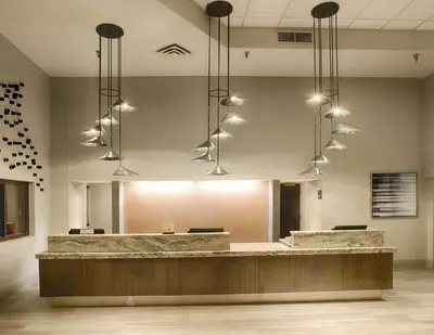 a lobby with a reception desk and pendant lights at DoubleTree by Hilton Denver/Westminister in Westminster