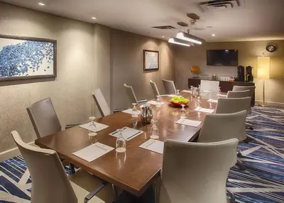 a conference room with a large wooden table and chairs at DoubleTree by Hilton Denver/Westminister in Westminster