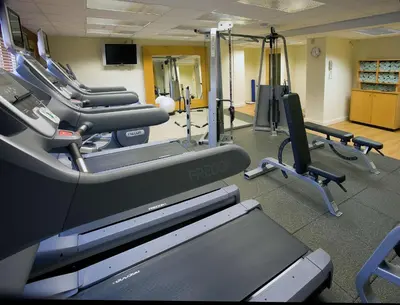 a gym with treadmills and machines in a room at DoubleTree by Hilton Denver/Westminister in Westminster